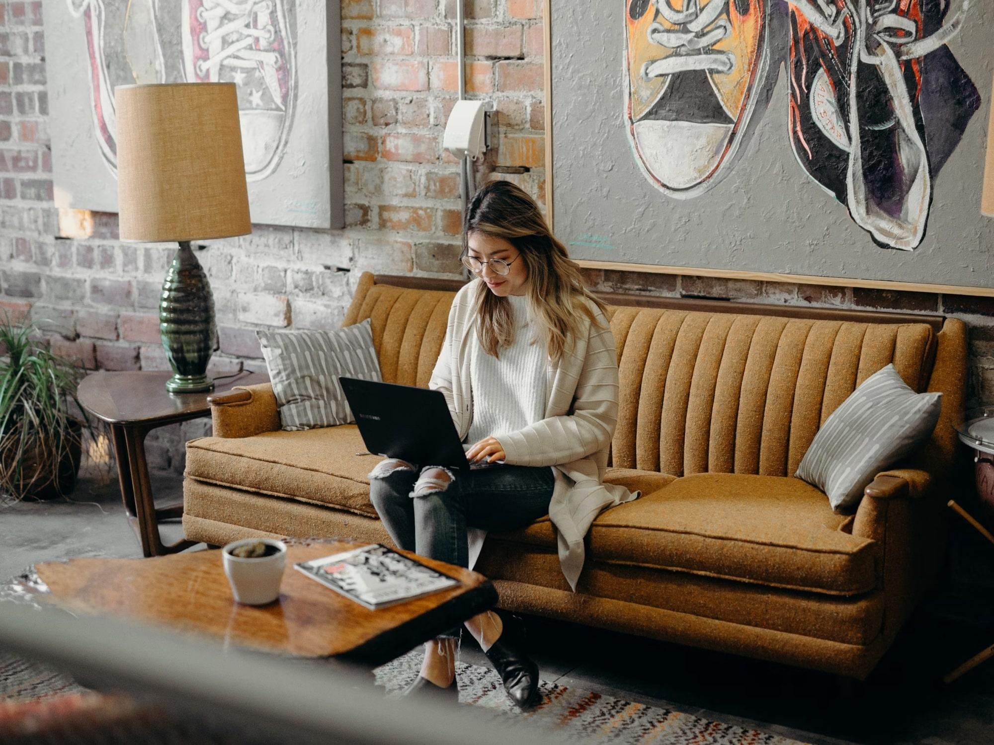 Woman on sofa with laptop