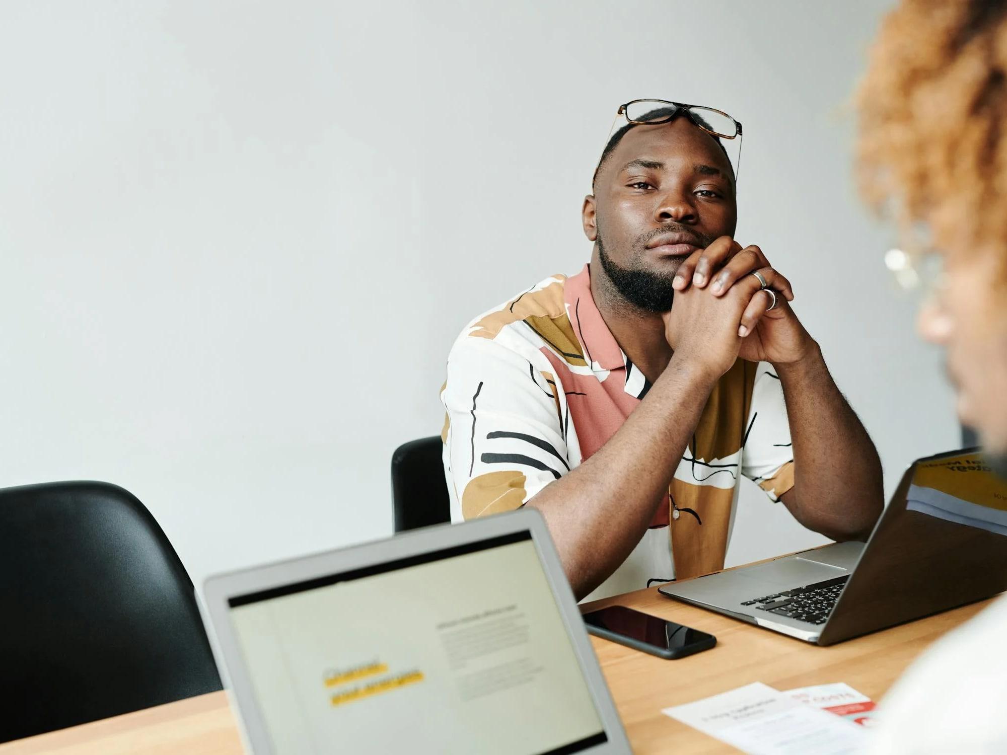 Person at desk with laptops